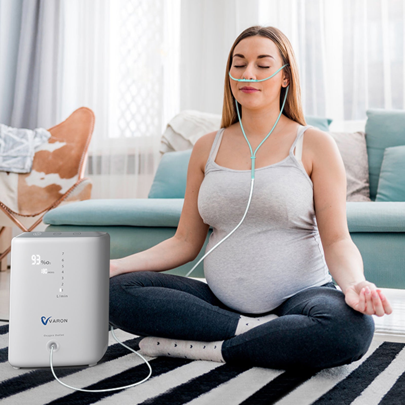 Pregnant woman receiving oxygen therapy during daily routine with VARON home oxygen concentrator